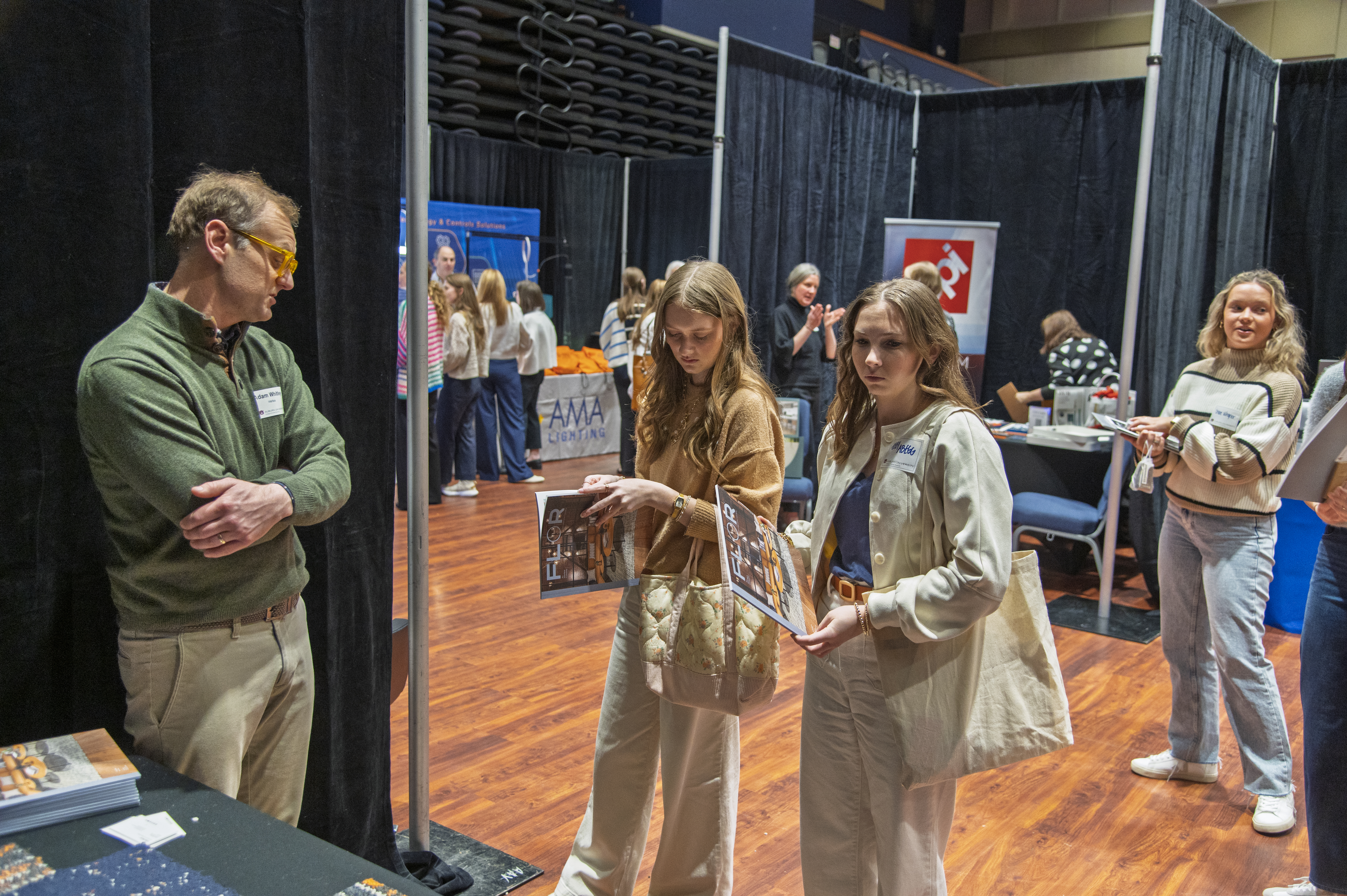 Students speak with a company representative at the INDS Product Fair