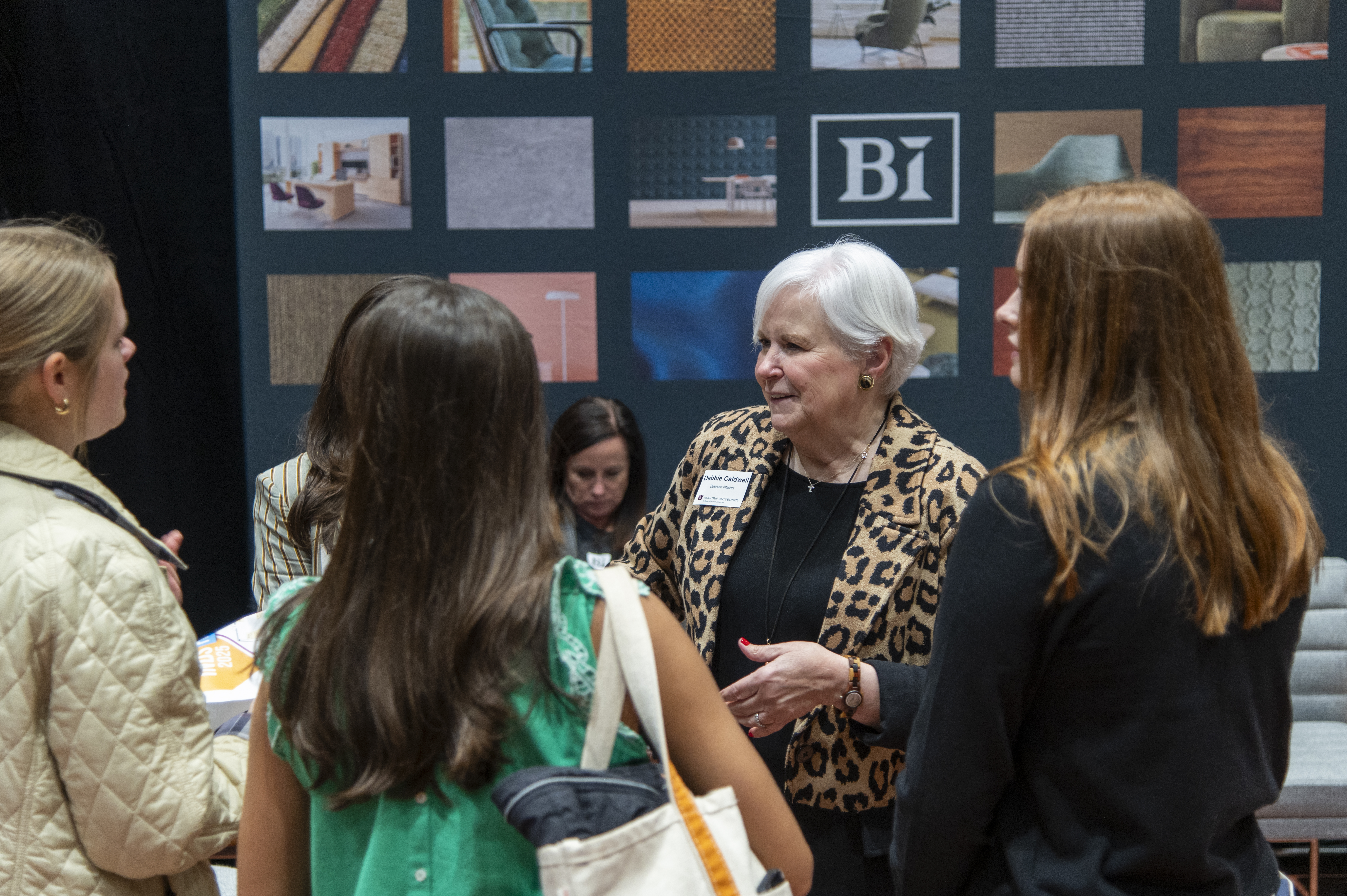 Students speak with a company representative at the INDS Product Fair