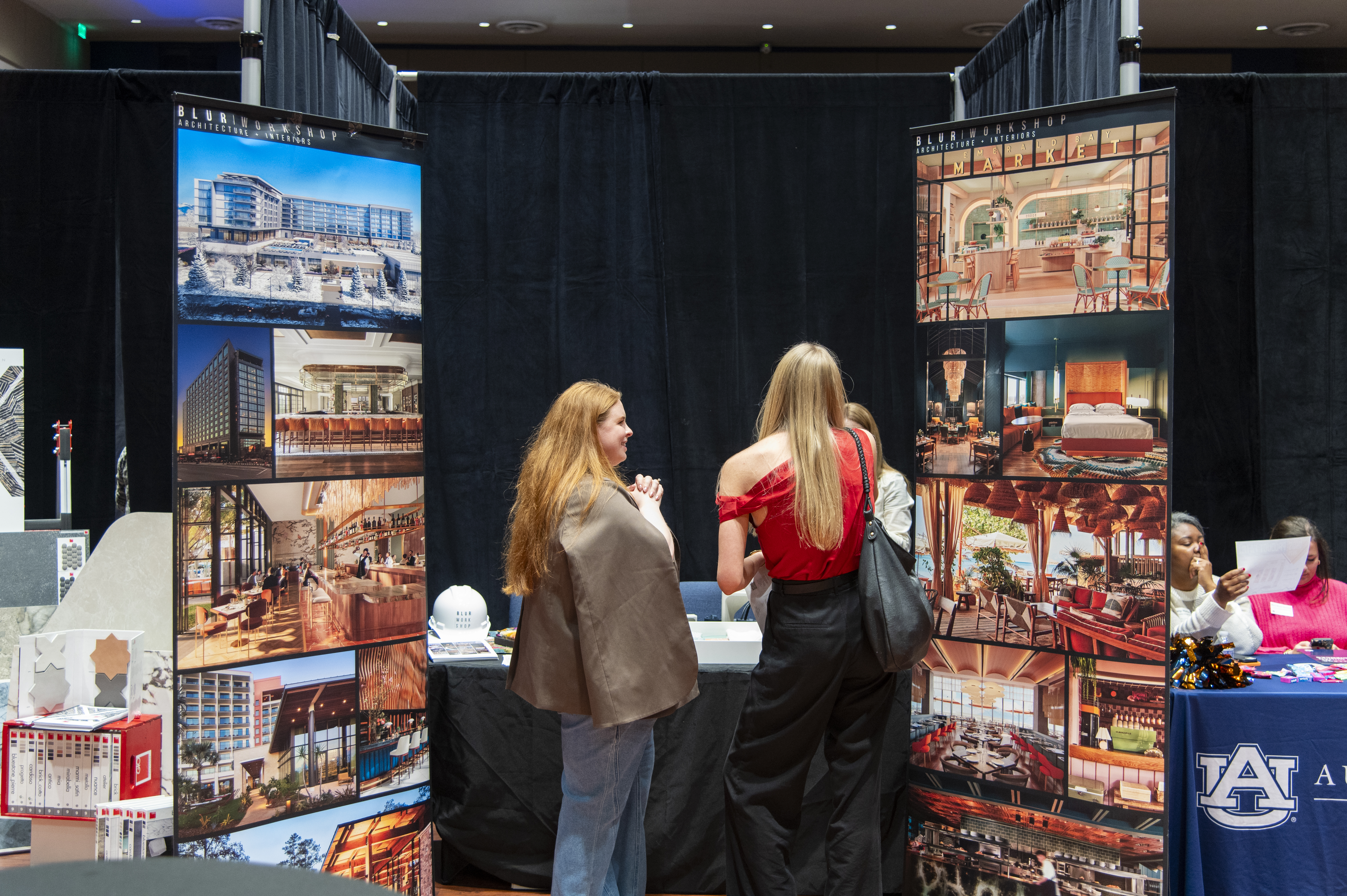 Students speak with a company representative at the INDS Product Fair