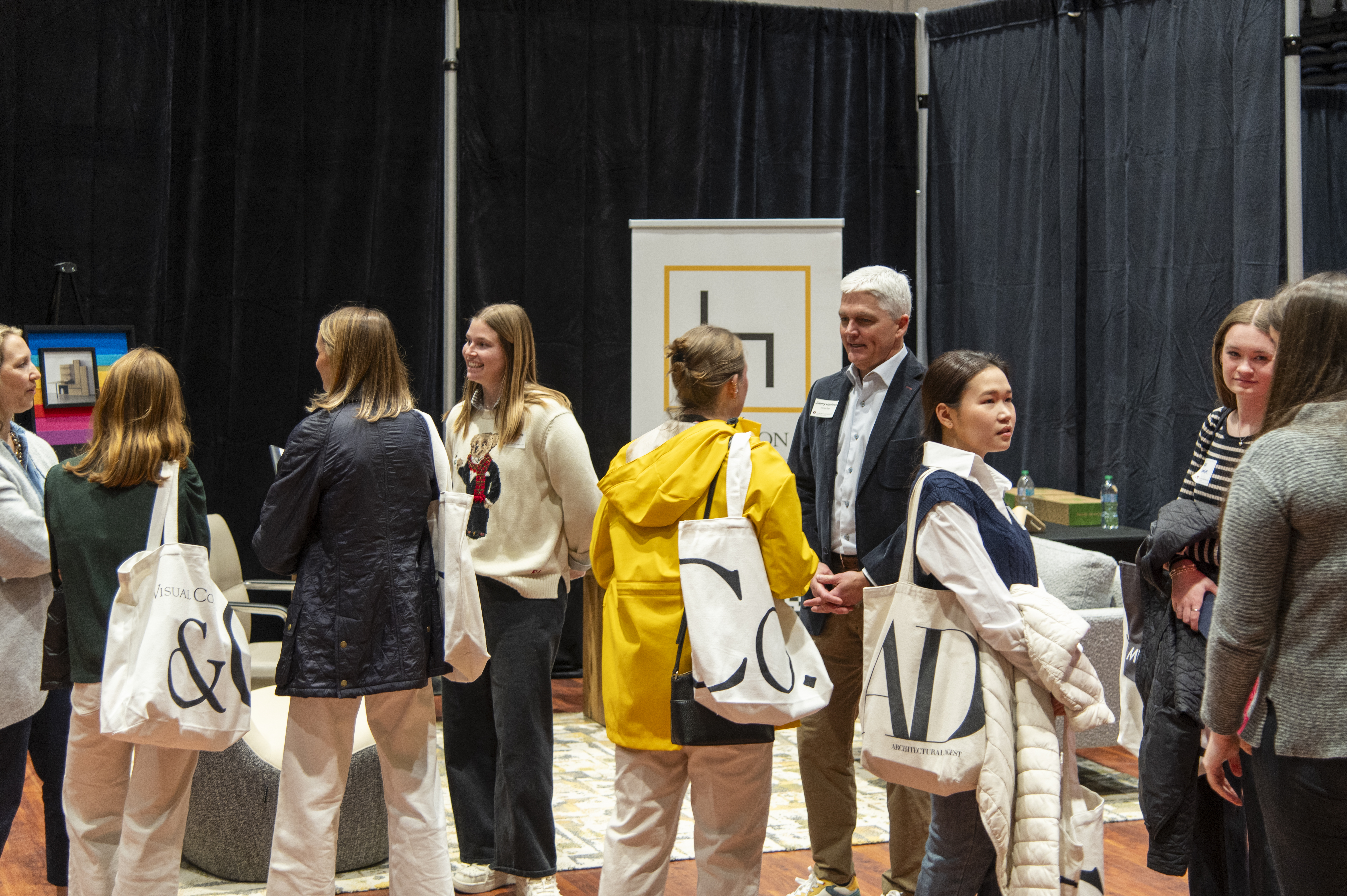 Students speak with a company representative at the INDS Product Fair