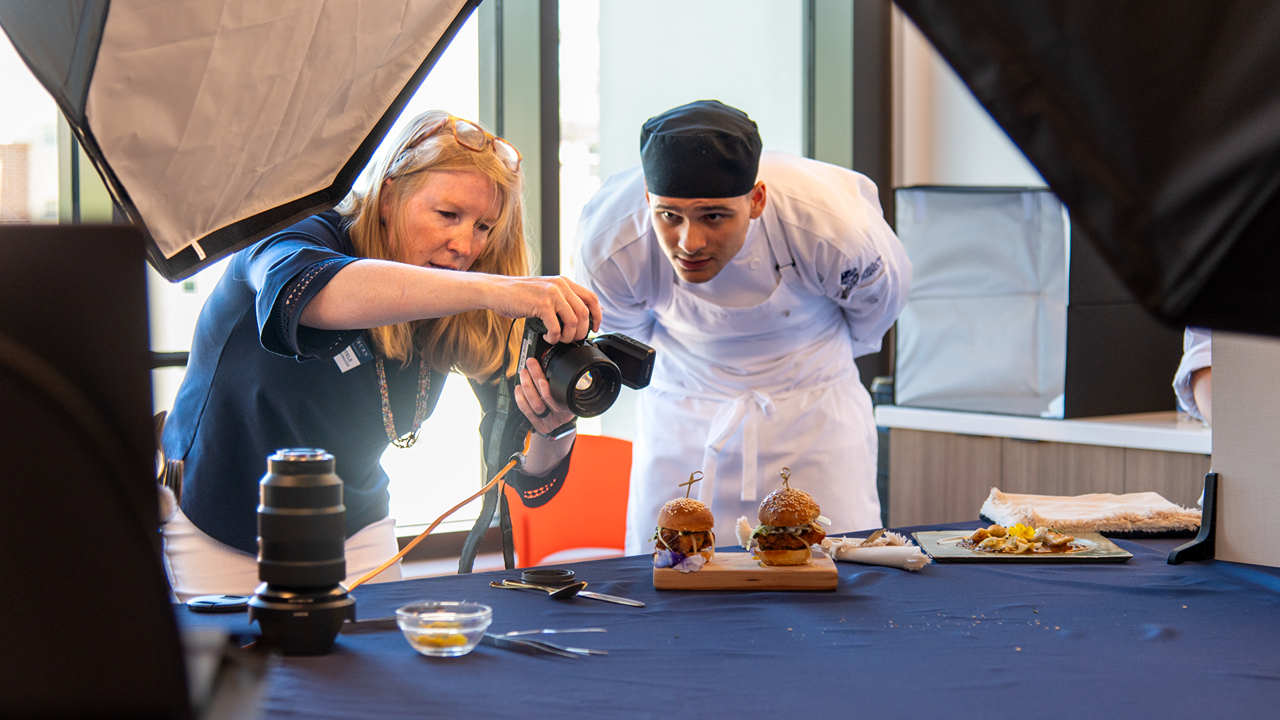 Damon Phillips, a sophomore studying culinary science, watches a food photography demonstration in the new  Graduate by Hilton Media Laboratory in the Tony and Libba Rane Culinary Science Center.