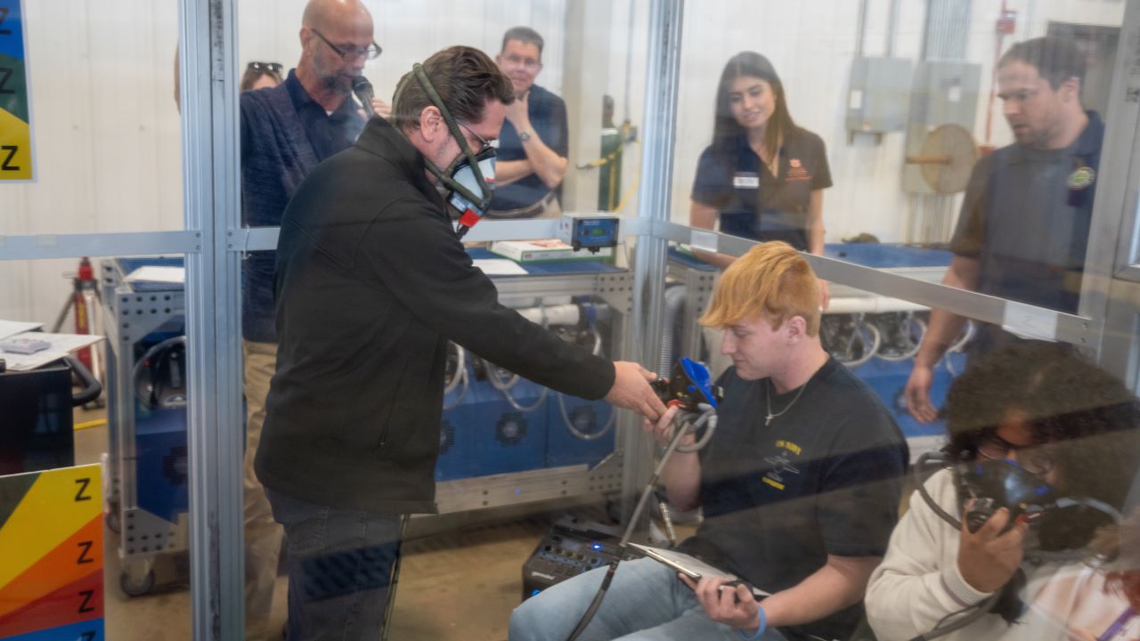 FAA instructor helps student put on oxygen mask