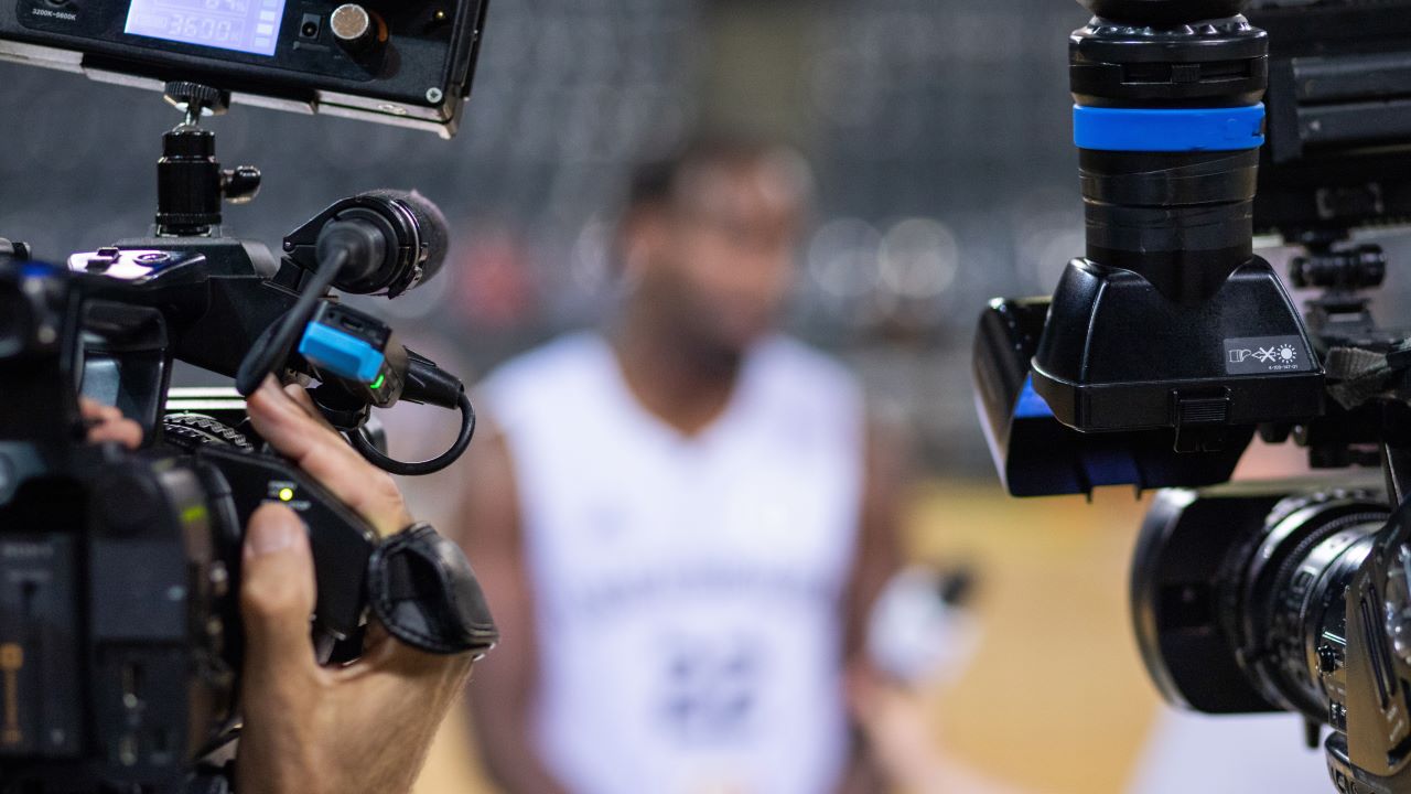 Videographers interview an athlete