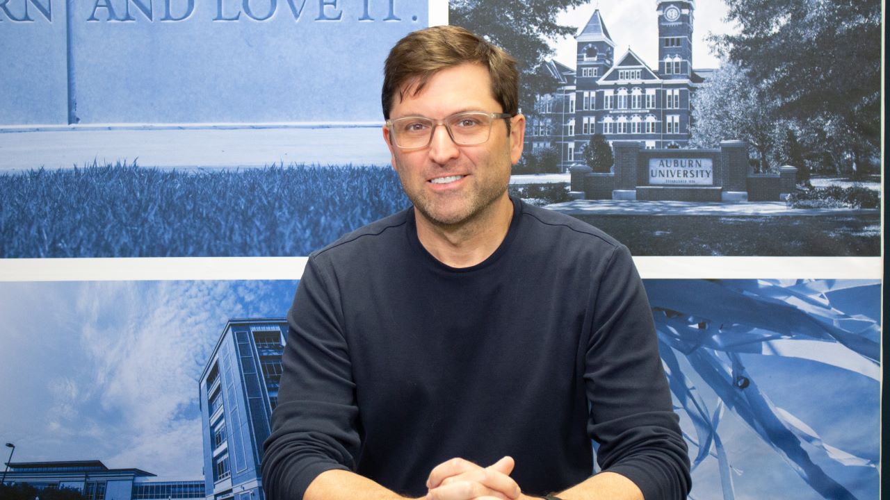 Andy Young sitting at broadcast desk