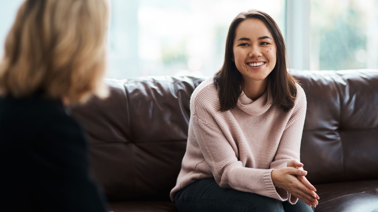 A woman smiling during a therapy session