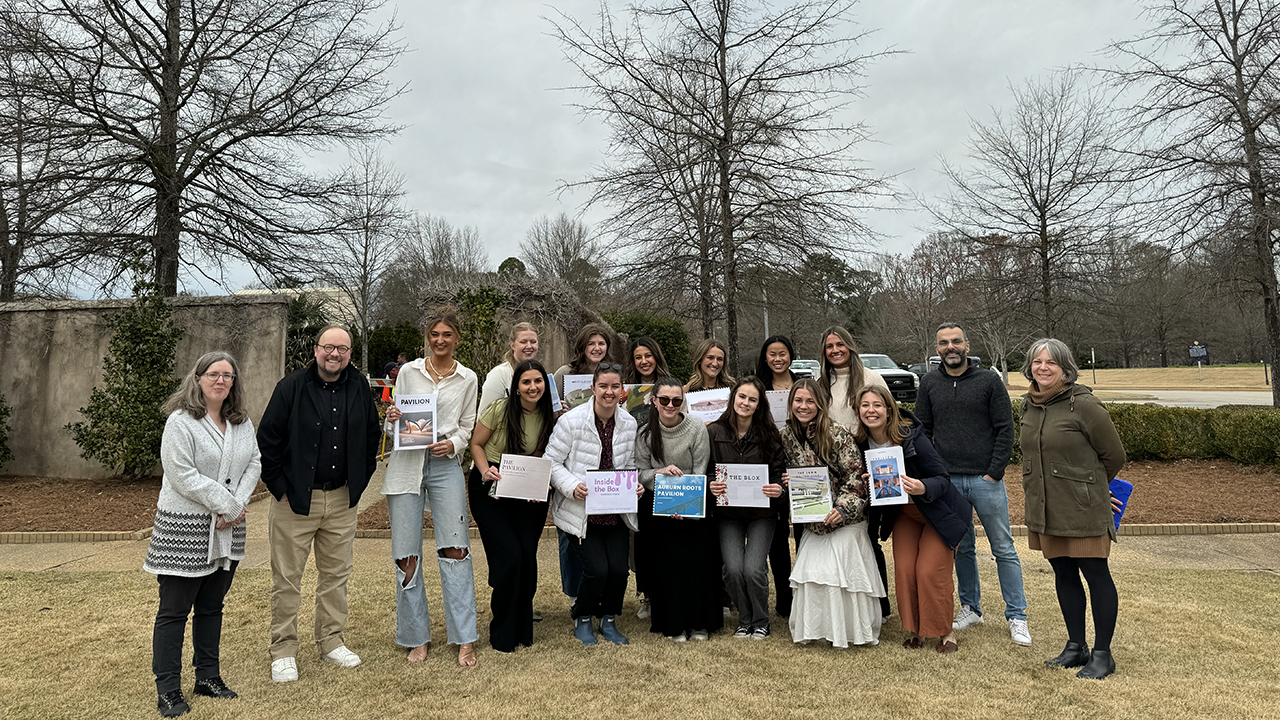 Interior design students pose with museum staff.