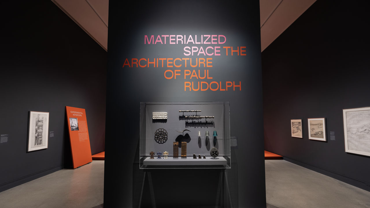 Gallery entrance to exhibition featuring objects and title