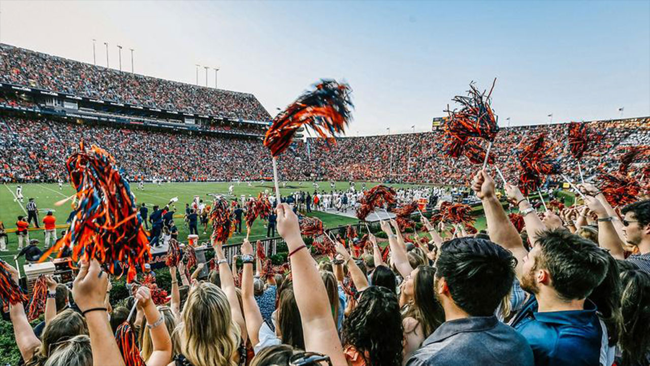 A crowd cheering inside Jordan-Hare Stadium