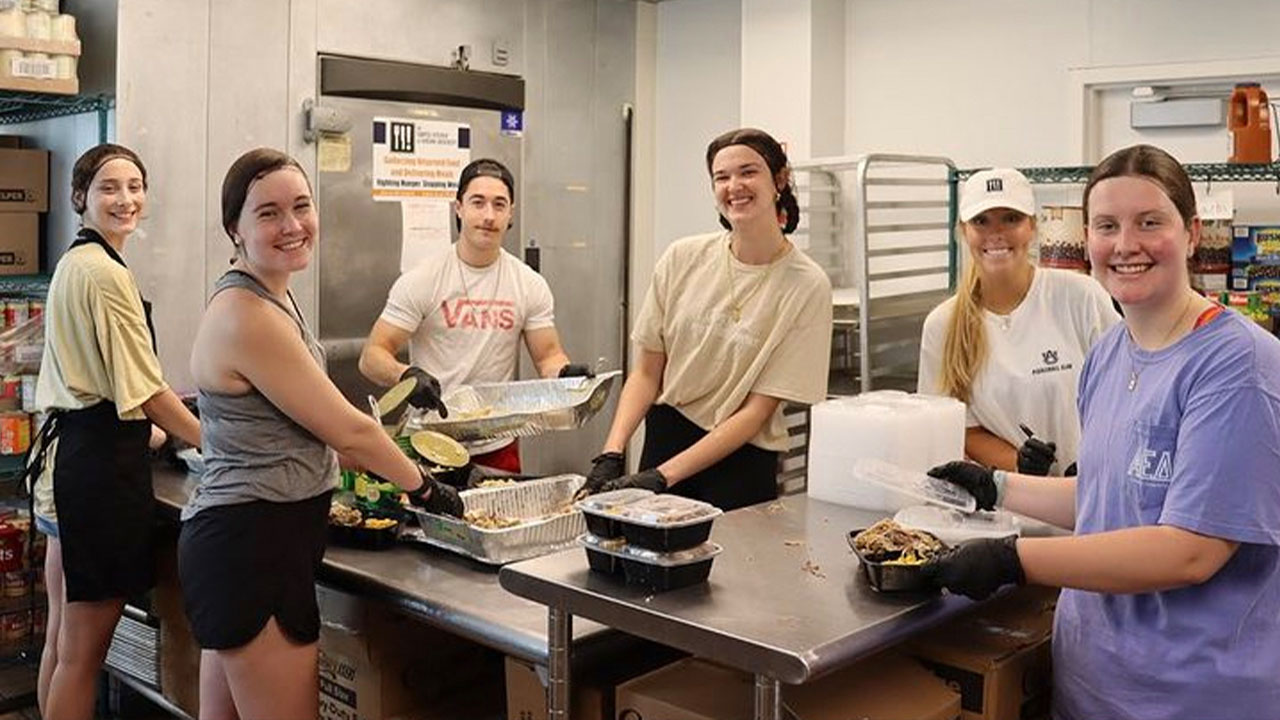 Students working with food in a kitchen