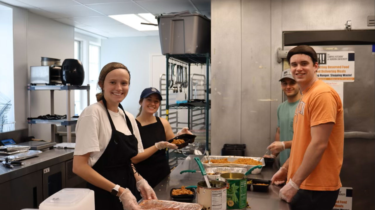 students work with food in a kitchen