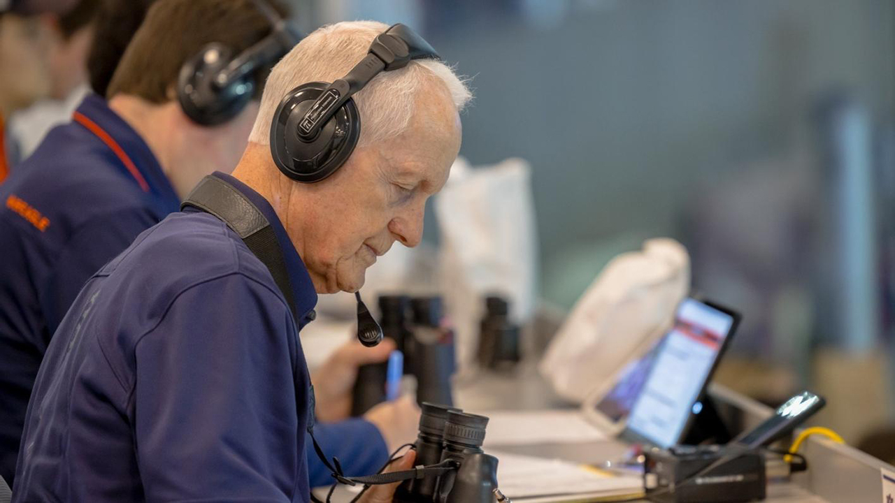 Tommy Elliott reviews statistics while sitting in the press box at an Auburn football game.