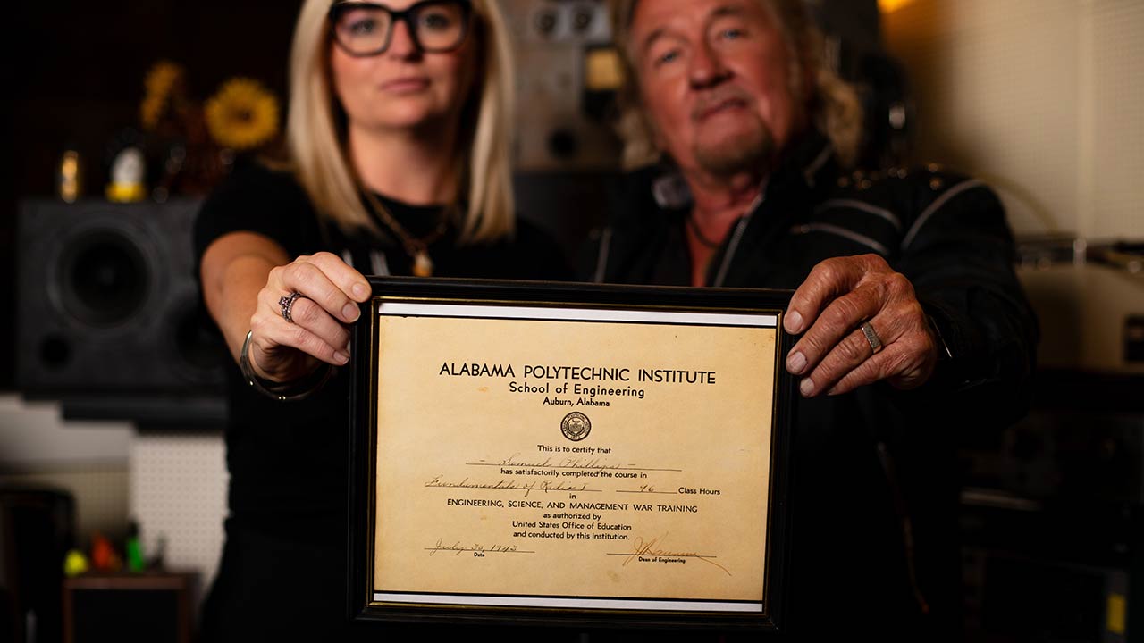 Halley and Jerry Phillips hold a certificate