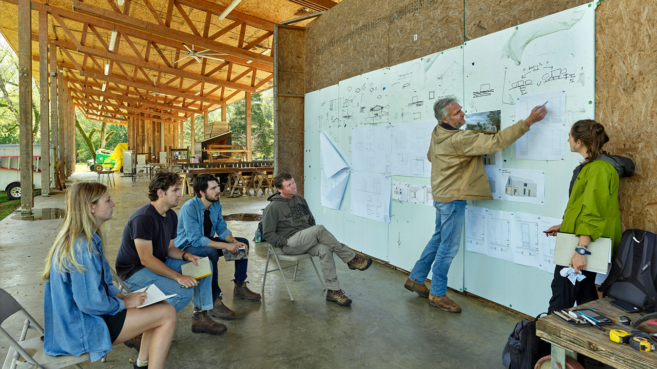 Andrew Freear works with students on a design-build project in Newbern, Alabama.
