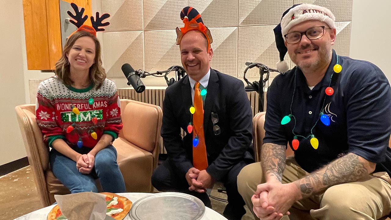 Picture of podcast host and guests indoors