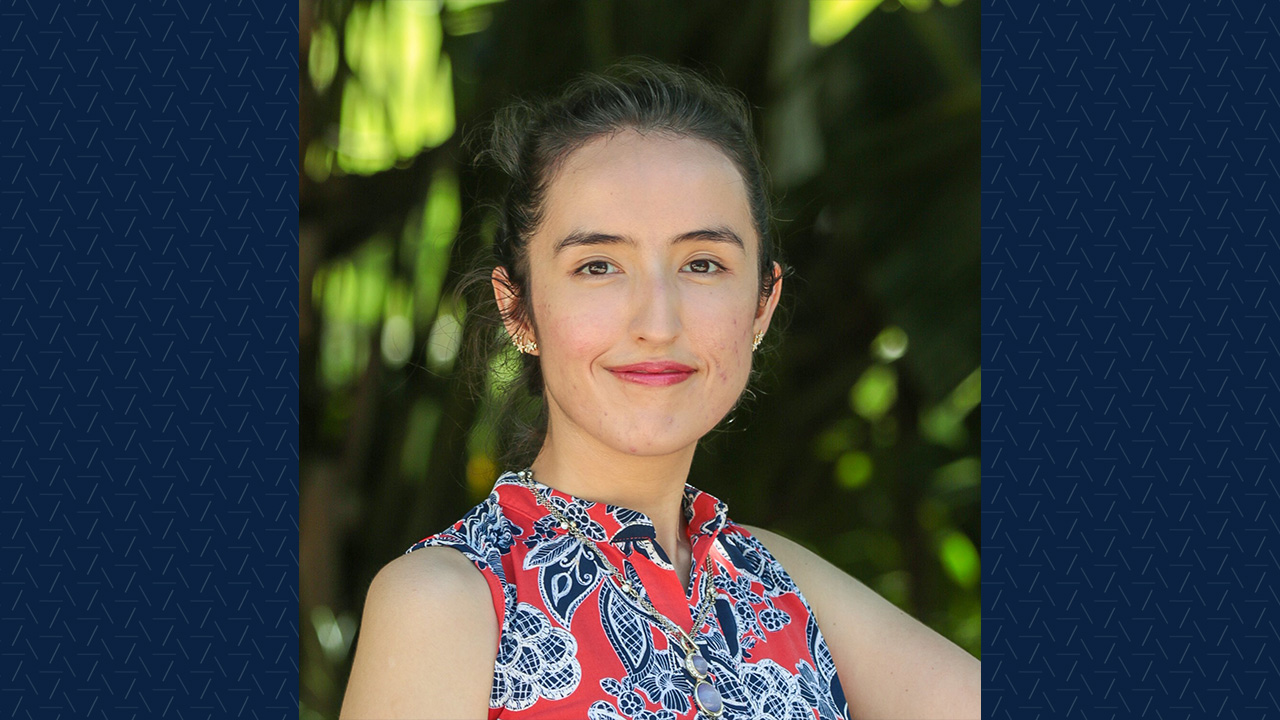 A woman poses for a headshot outside