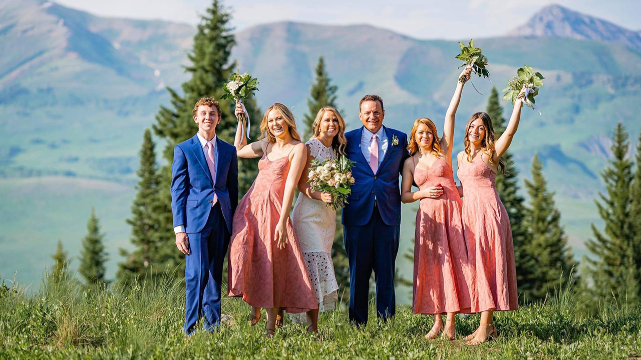 A family poses for a photo in the mountains of Colorado