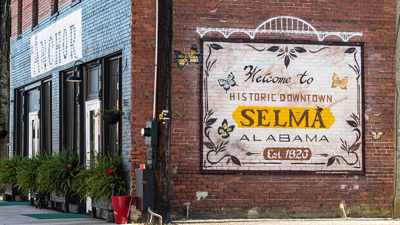 A painted brick wall on an old building welcomes visitors to Selma