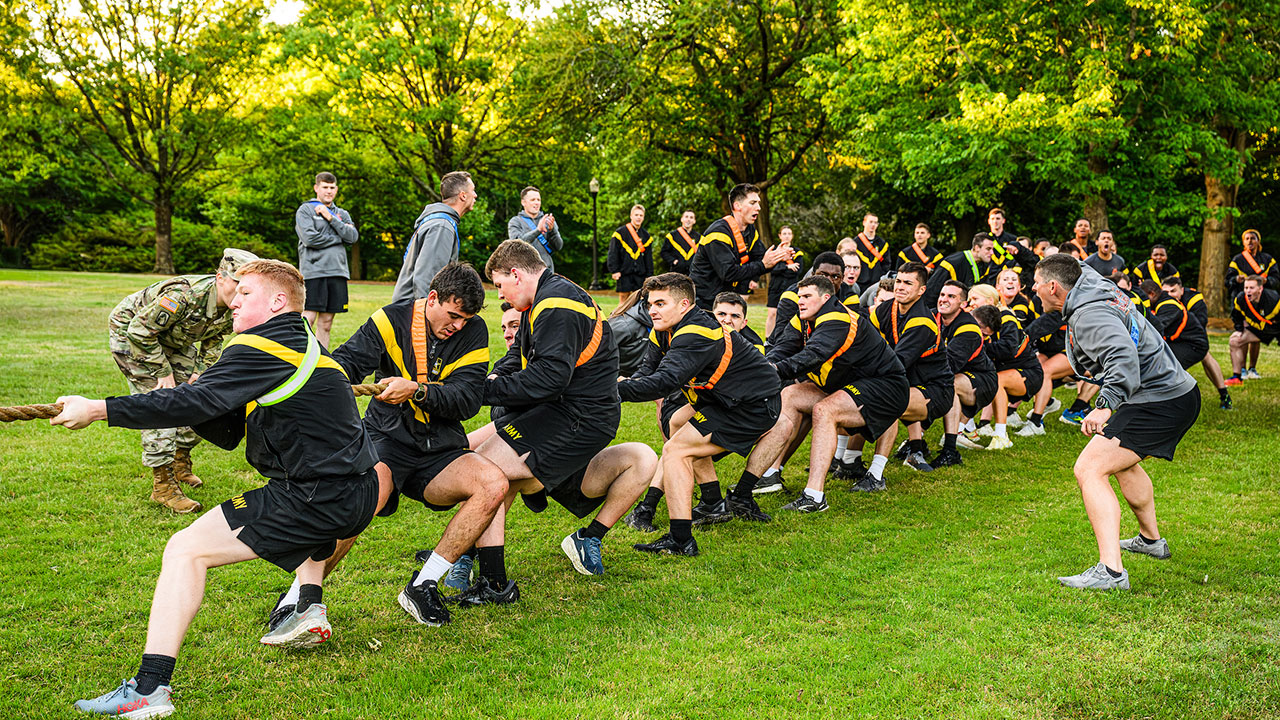 Auburn ROTC students actively pull a rope during a tug-of-war event.