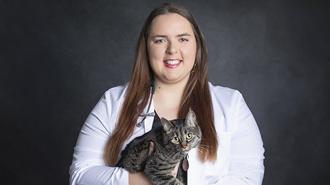 VetMed student Lexie Craig holds a cat.