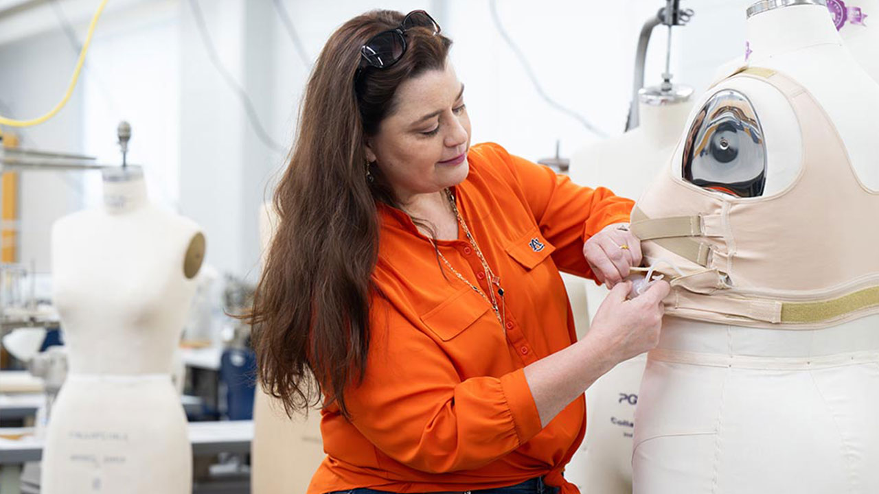 An Auburn researcher is pictured working with apparel design.
