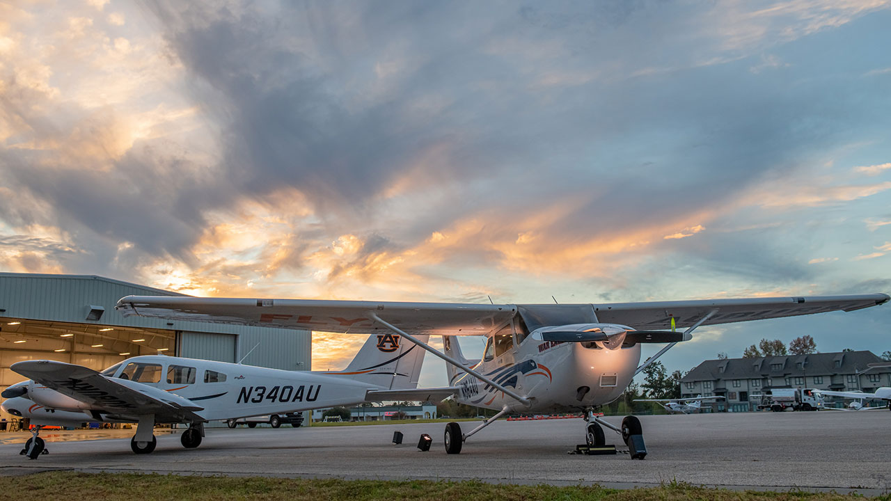 Auburn planes sit outside a hangar