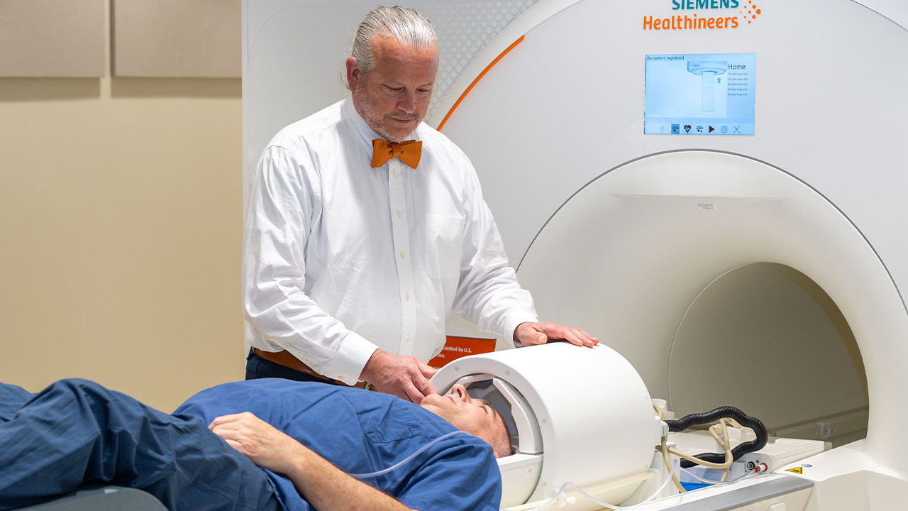 Tom Denney secures a patient in the 7T MRI.