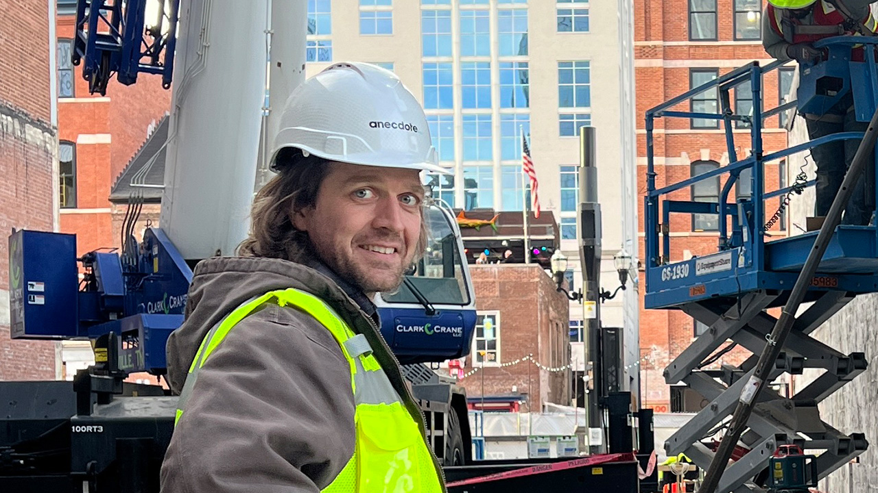 A man in a construction vest visits a construction site