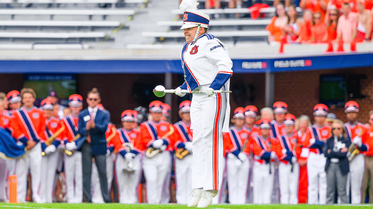 The band major jumps on Jordan-Hare field.