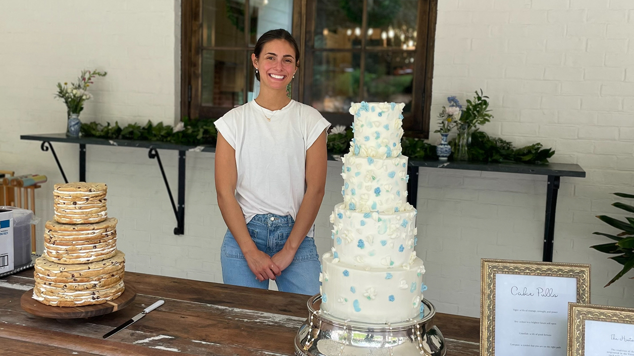 Sophie Snyder stands with some of her cakes