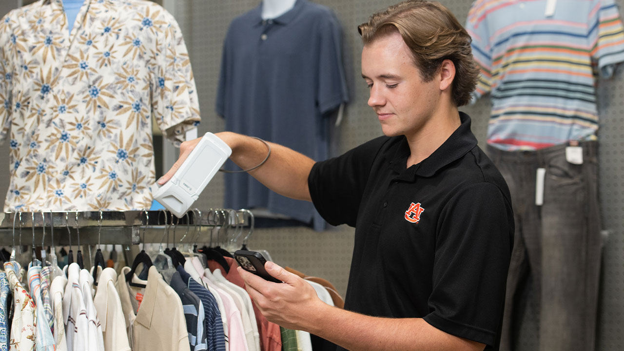 a student scans an RFID chip in the lab's mock retail store