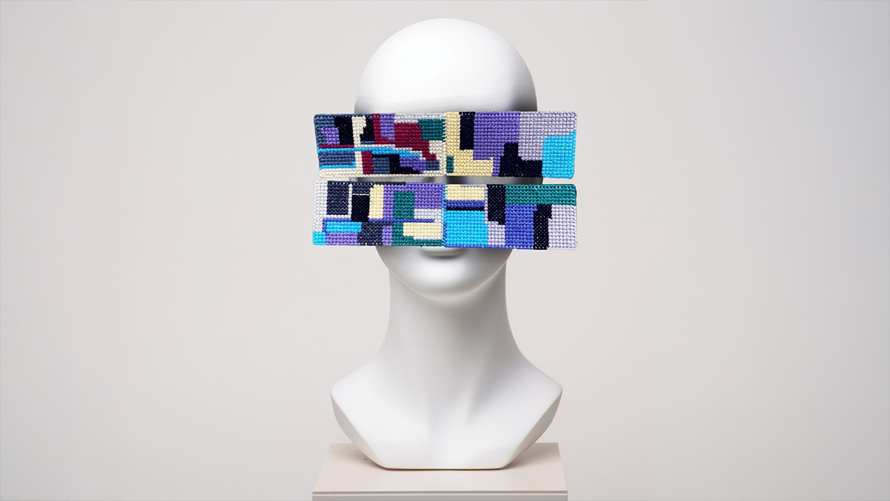 art work featuring a beaded mask on a white mannequin