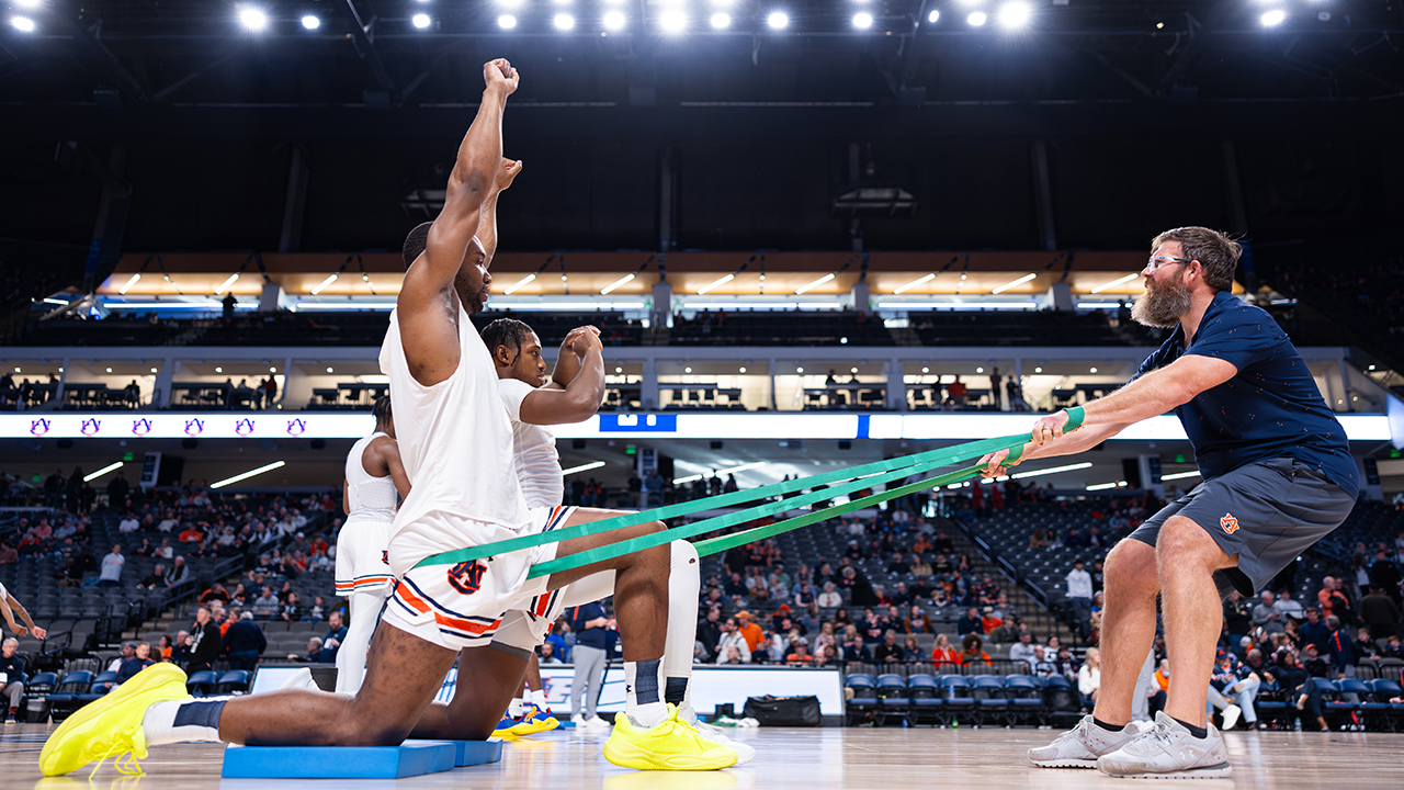 Coach training a basketball player.