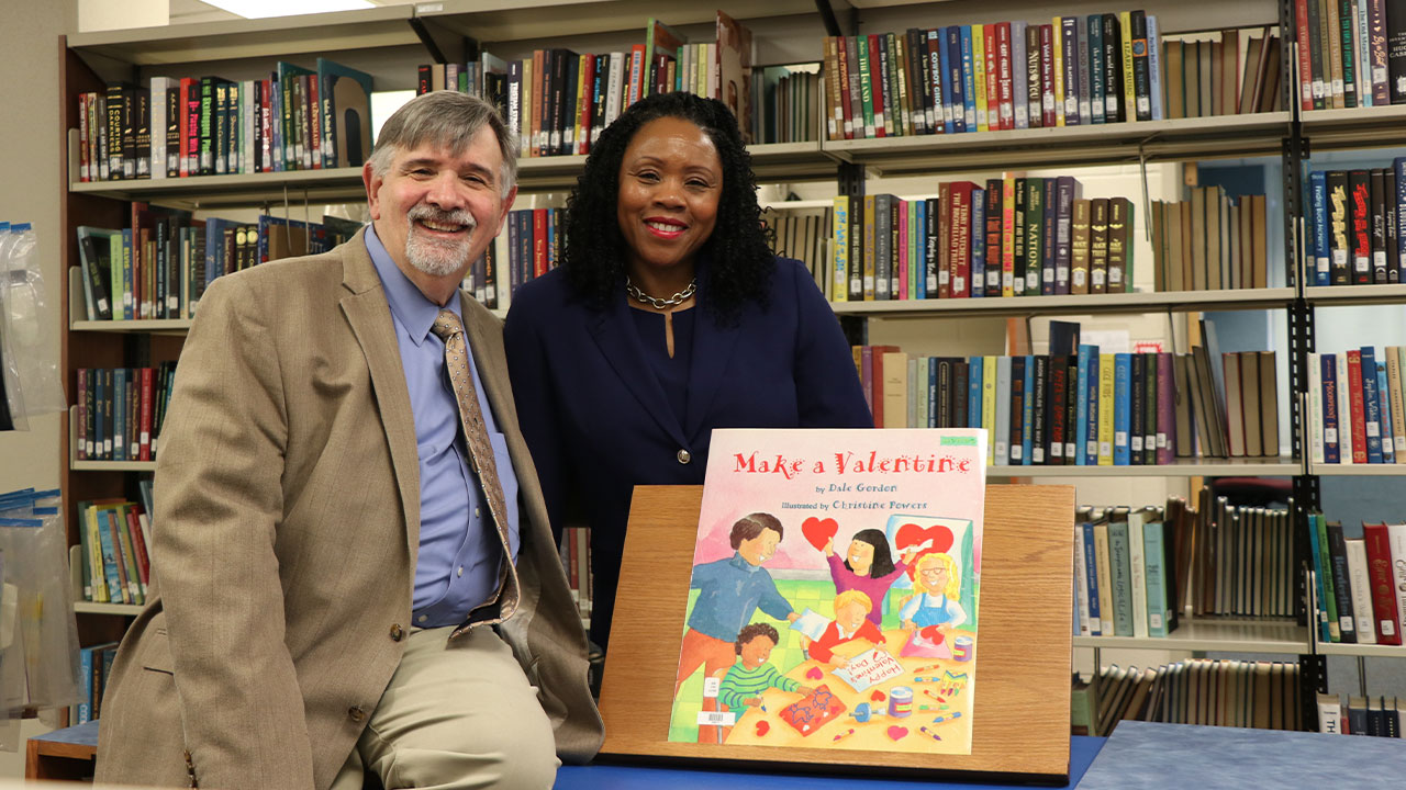 Gary Martin and Marilyn Strutchens stand in a library