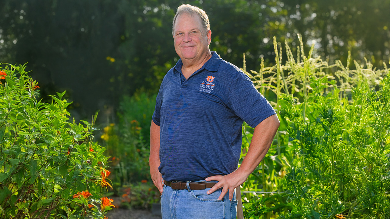 James Lindner stands in a field of flowers