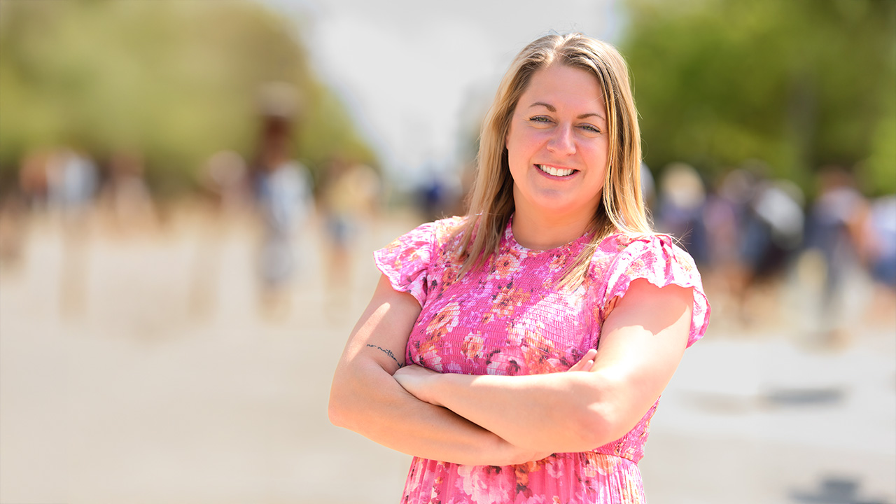 Allison stands on a crowded sidewalk
