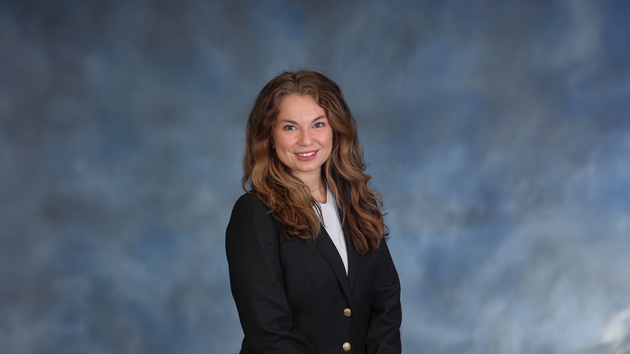 Maddie Larkin smiles for a headshot.
