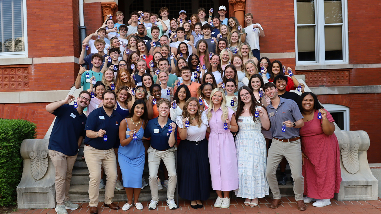 The Camp War Eagle head orientation counselors smile for a photo on the steps of Samford Hall with the CWE counselors behind them