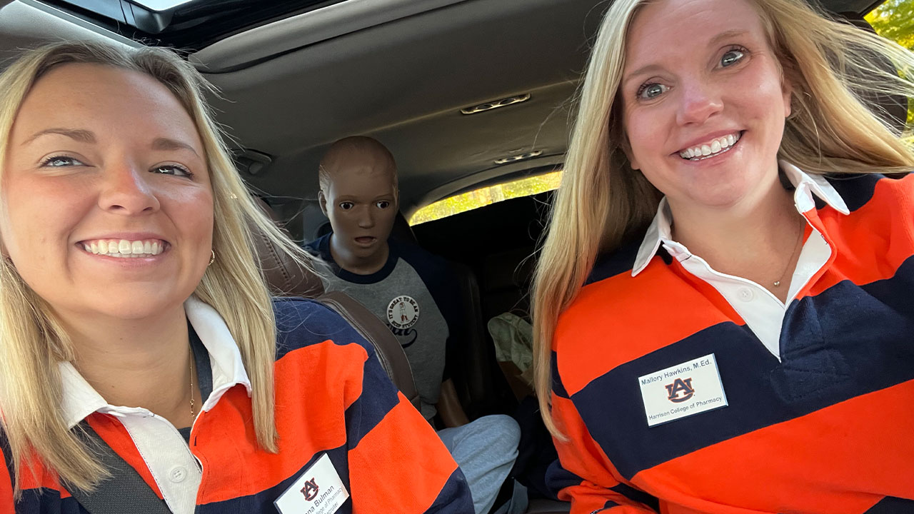 a student, walker and Mallory Hawkins take a car selfie