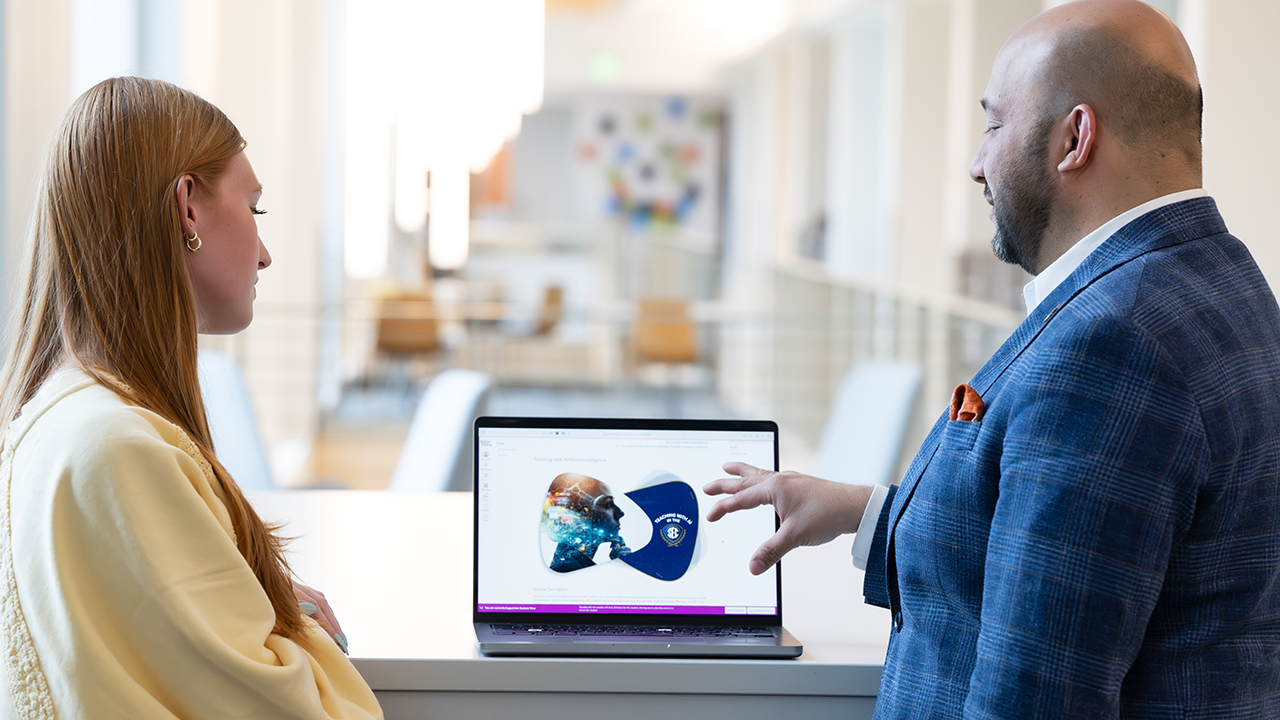 Professor showing student work on computer