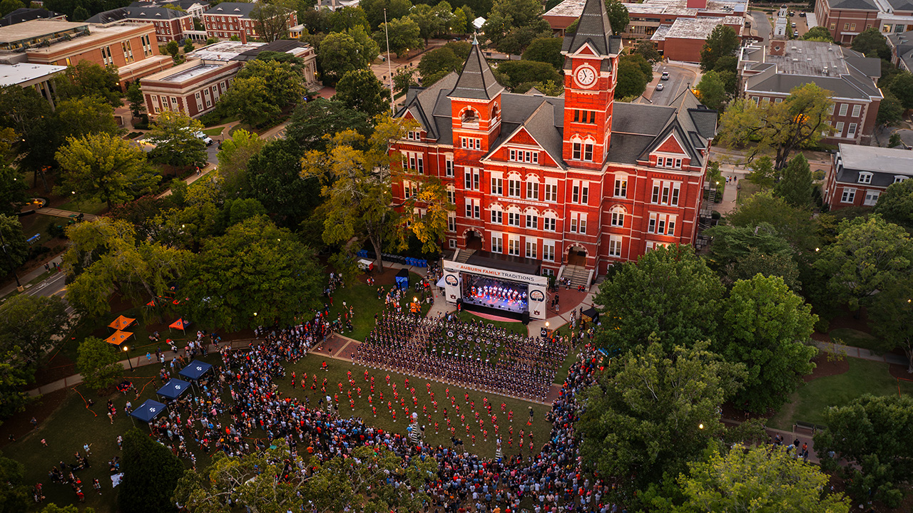 An aerial shot of Samford Hall with people standing around a stage