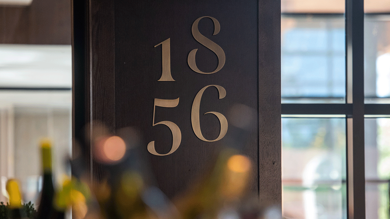 The numbers 1856 on a black wall.