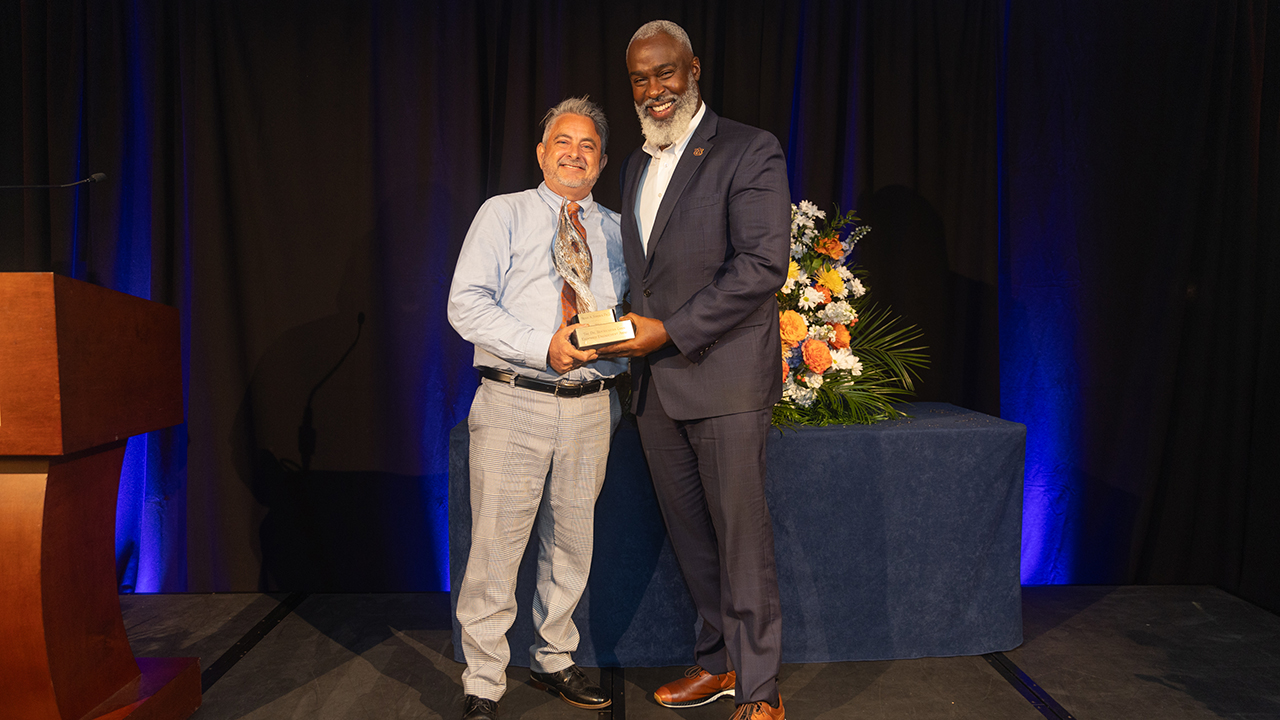 Sean Forbes receiving the Royrickers Cook Endowed Engagement Award - presented by the VP for University Outreach, Royrickers Cook