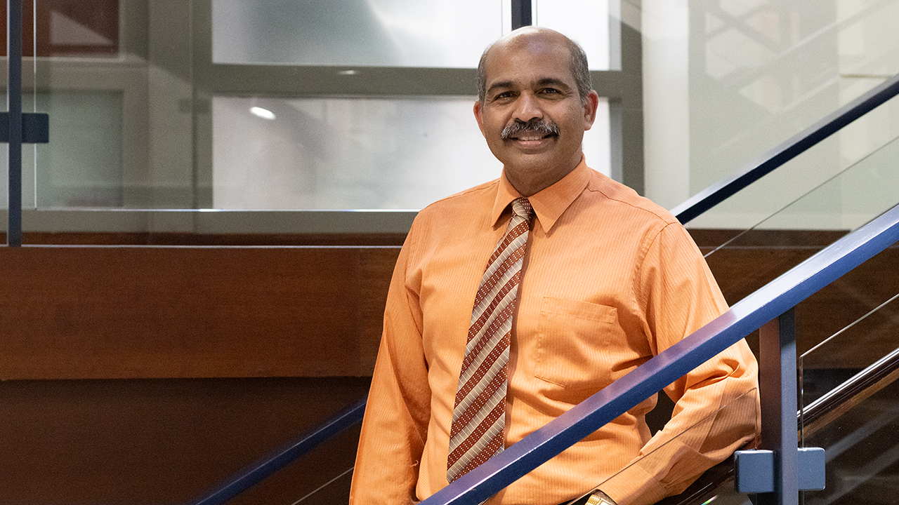 Muralikrishnan Dhanasekaran stands on stairs