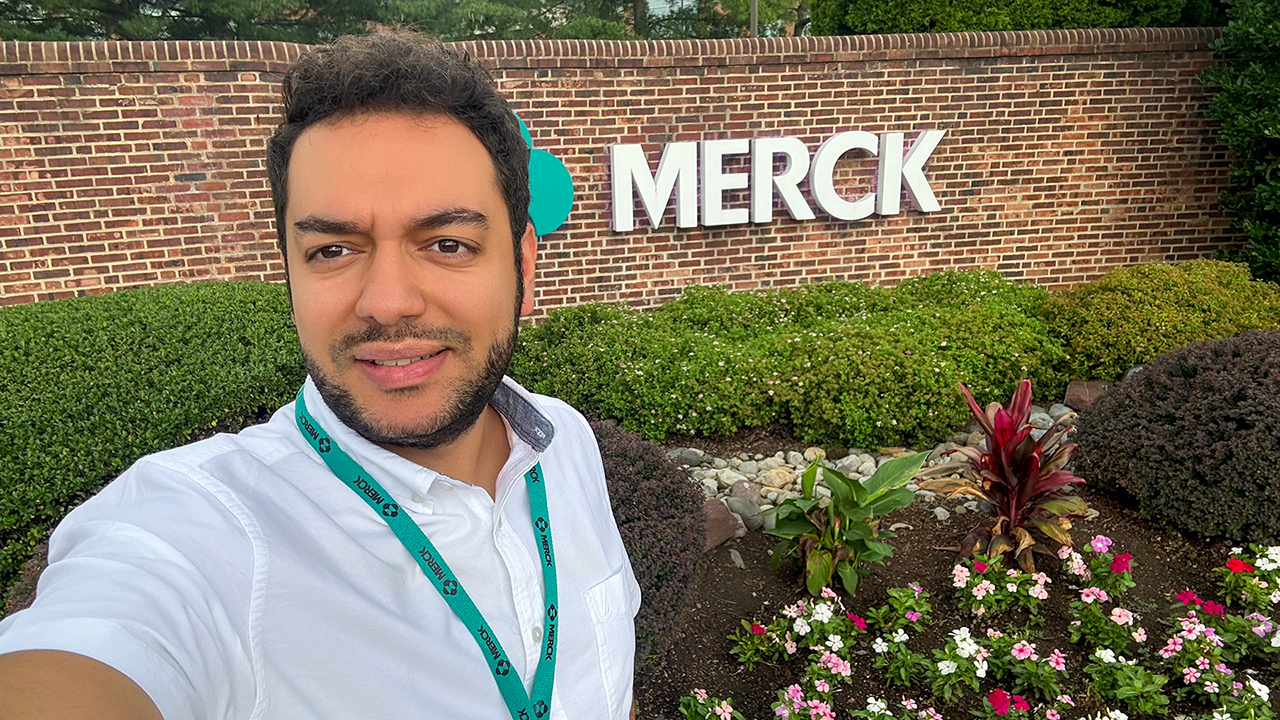Person stands in front of Merck sign