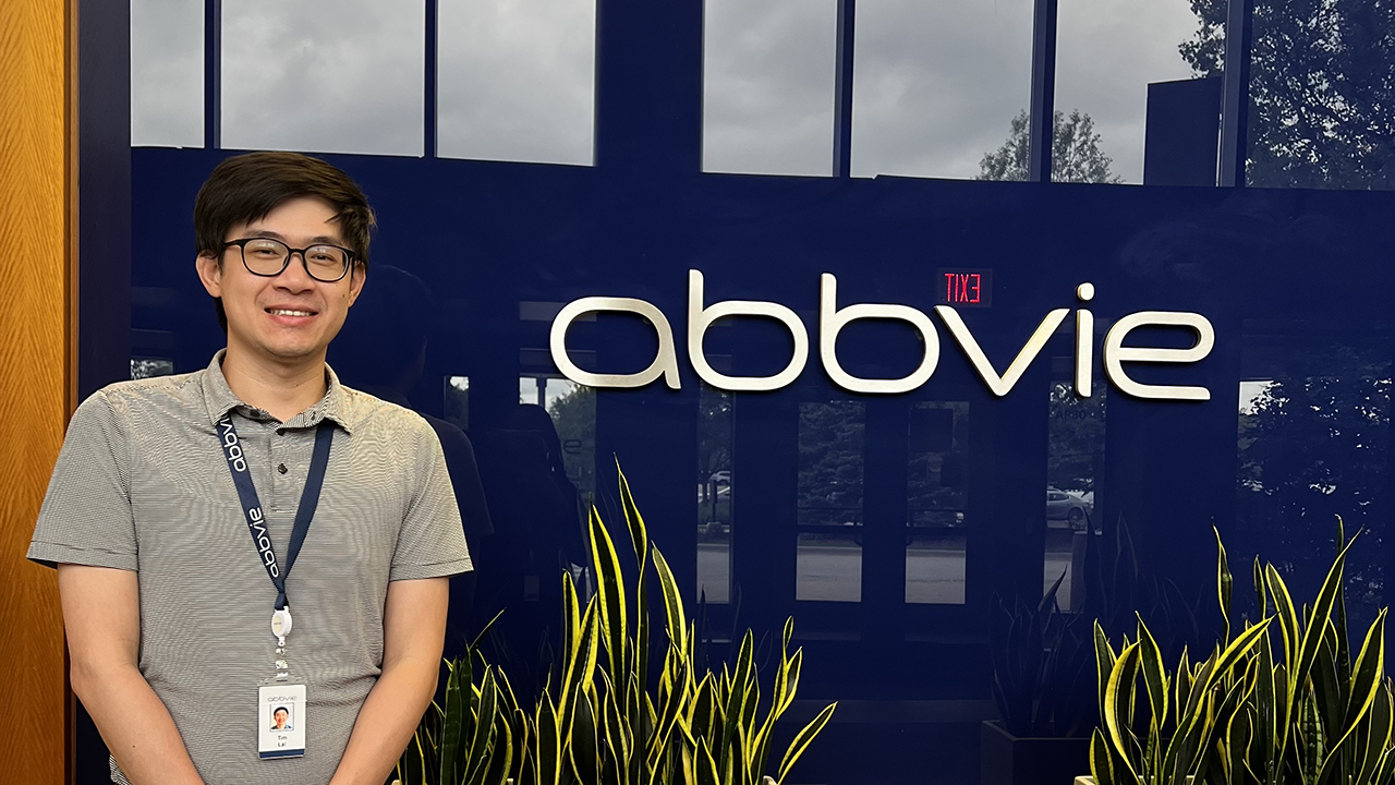 Person stands in front of AbbVie sign