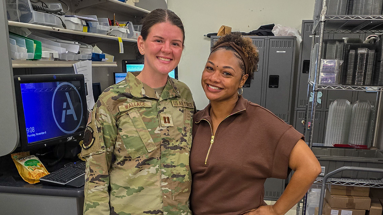 Two people stand together in a pharmacy