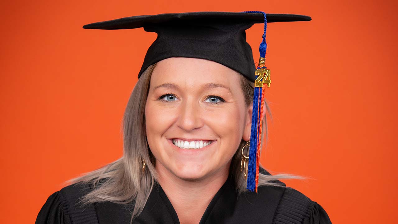 Court Green-Johnson, a senior animal science major, poses for graduation photos in her cap and gown