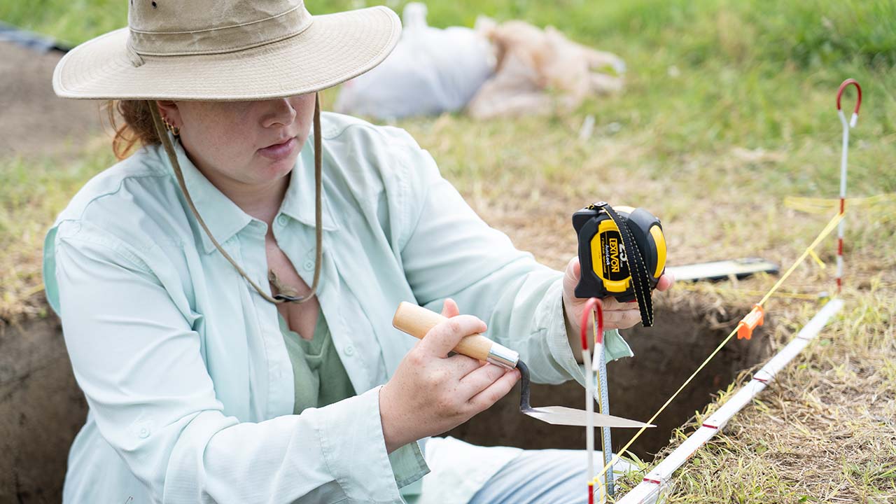 A College of Liberal Arts student measures findings during a recent Archaeology Field School in Notasulga, Alabama.