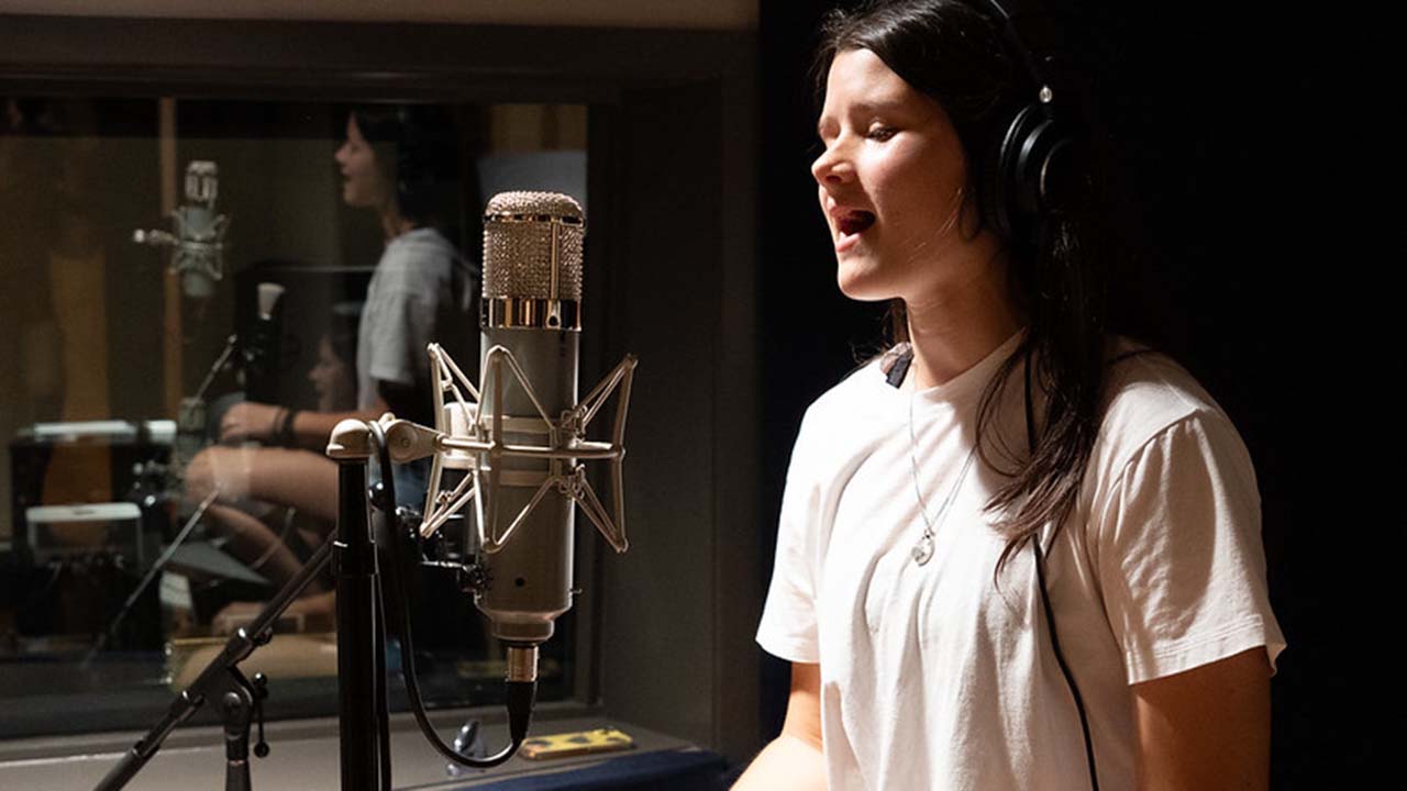 Student singing in the Lucky Man Recording Studio