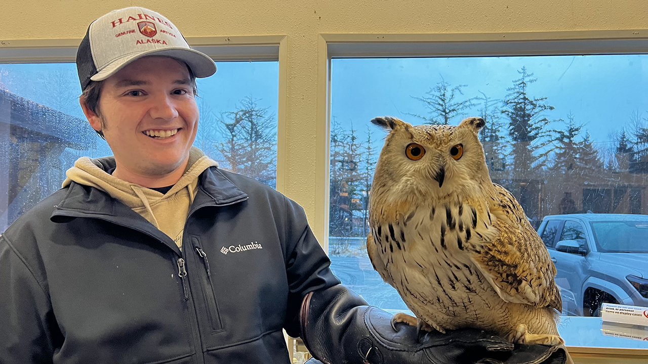 Gabe Hallmarks hold Ahsoka, a Siberian eagle owl. 